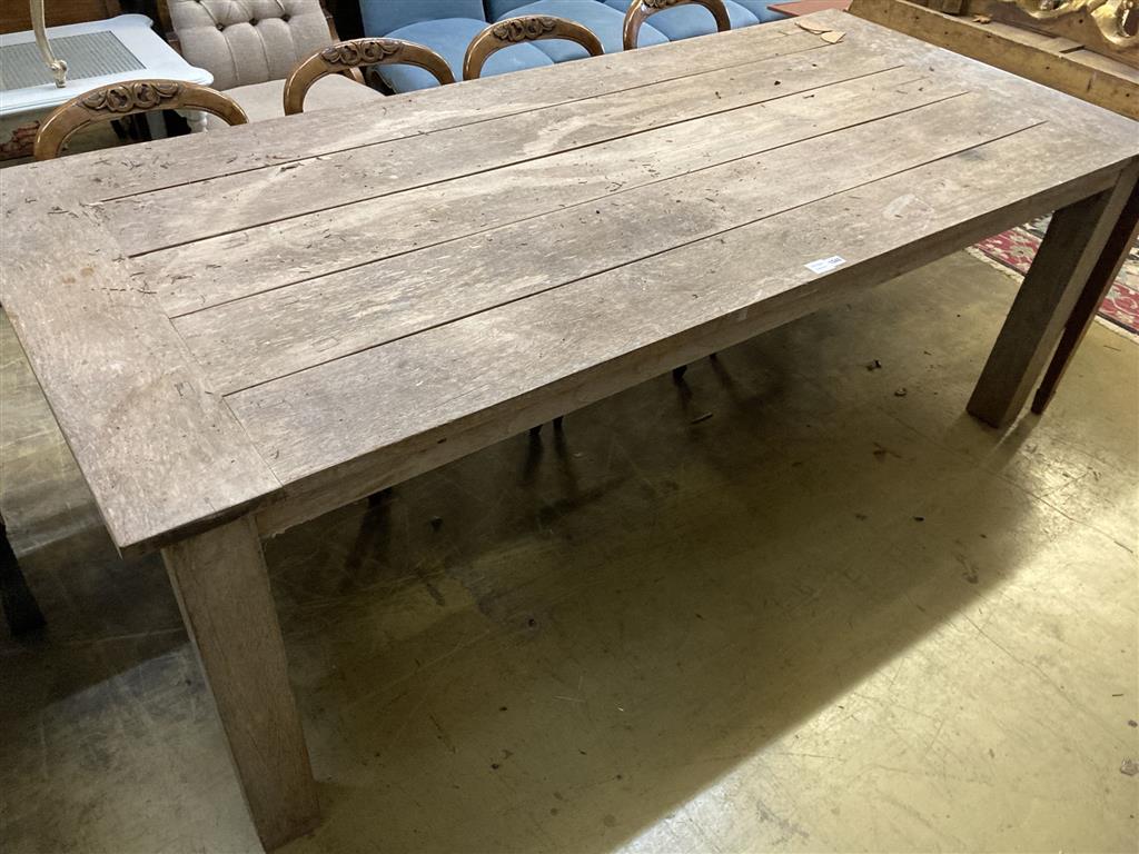 A large rectangular weathered teak garden table, width 220cm, depth 99cm, height 79cm